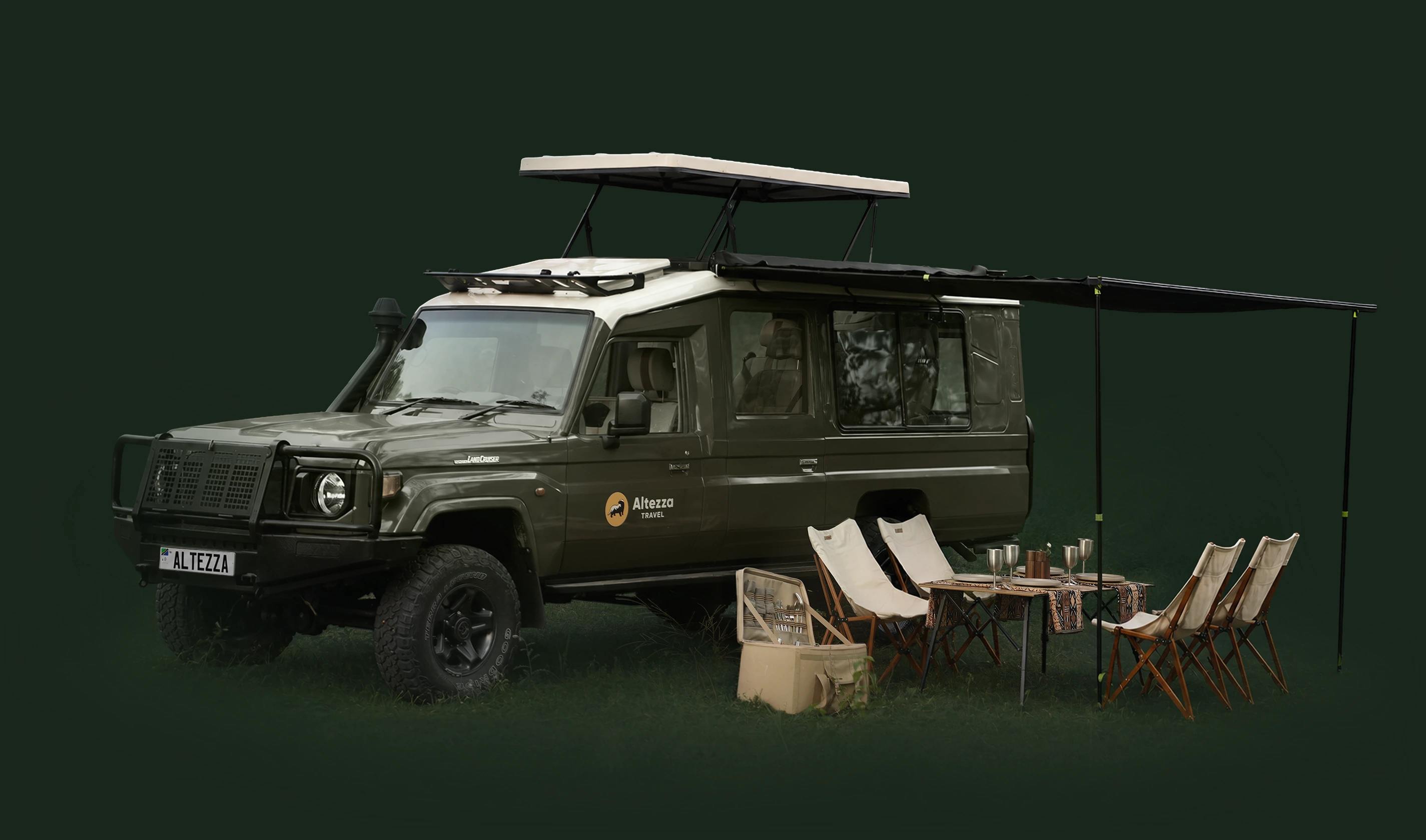 Safari vehicle with an awning, dining table, chairs and picnic case set up for bush lunch